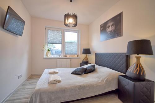 a bedroom with a bed with two pillows on it at Apartament Cinema in Mielno