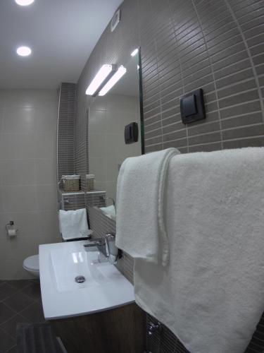 a bathroom with a white sink and a mirror at M48 apartments in Belgrade