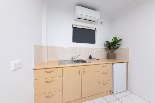 a small kitchen with a sink and a window at Hotel Forster in Forster