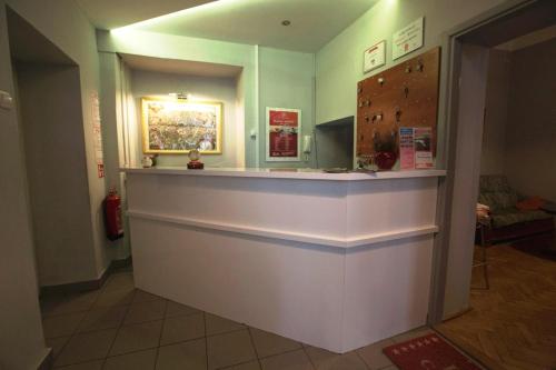 a lobby with a counter in a room at Red Carpet Hostel in Krakow