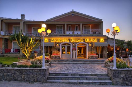 a hotel with a sign that reads michica beach hotel at Molfetta Beach Hotel  in Gouvia