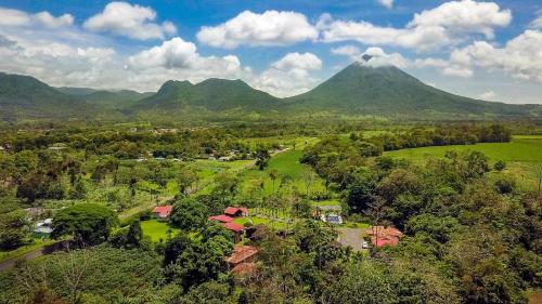 an aerial view of a mountain with a village and trees at Hotel Eco Arenal in Fortuna