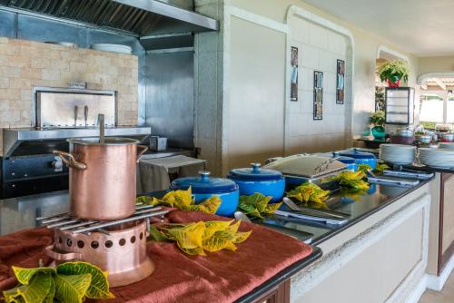 a kitchen with a counter with a pot on a stove at Fairmont Royal Pavilion Barbados Resort in Saint James