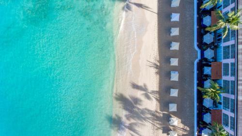 an overhead view of a beach with palm trees and the ocean at Fairmont Royal Pavilion Barbados Resort in Saint James