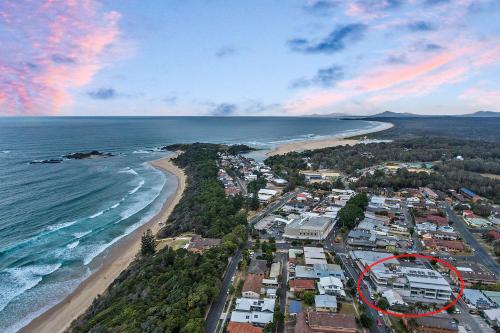 an aerial view of a beach with a red circle at No 5 Rockpool 69 Ave Sawtell in Sawtell