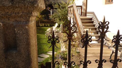 a wrought iron gate in front of a house with stairs at Appartement Pichler in Dobbiaco