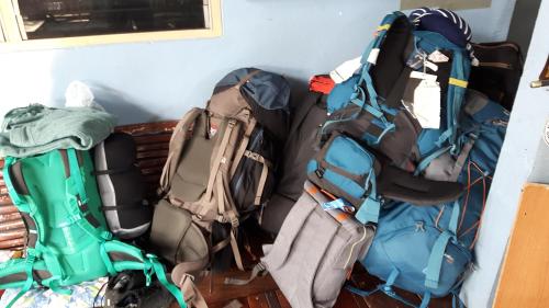 three pieces of luggage sitting next to a wall at Canaan in Kanchanaburi