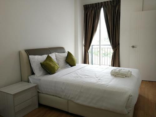 a bedroom with a large white bed with a window at Omni Cassia Hill Resort in Cameron Highlands
