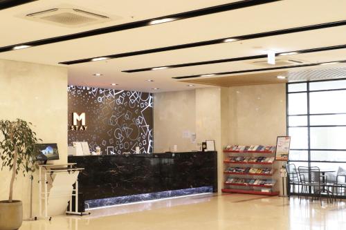 a store lobby with a sign on the wall at Mstay Hotel in Seogwipo
