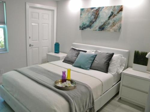 a bedroom with a bed with a tray with candles on it at Pompano Beach Hidden Gem in Pompano Beach