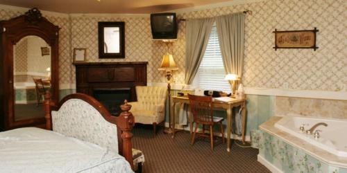 a bedroom with a bed and a desk and a tub at Elk Forge Bed and Breakfast in Elkton
