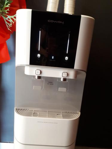 a close up of a coffee maker sitting on a table at Hotin Inn in Kuching