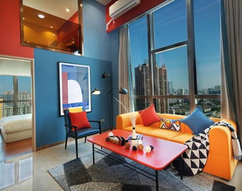 a living room with a orange couch and a red coffee table at Royal Star Apartment(Guangzhou Central City Branch) in Guangzhou