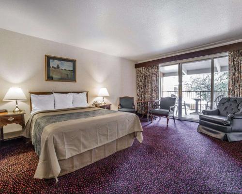 a hotel room with a bed and a balcony at Econo Lodge Near Reno-Sparks Convention Center in Reno