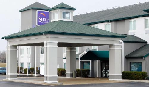 a hotel with a sign on top of a building at Sleep Inn & Suites Oregon - Toledo in Oregon