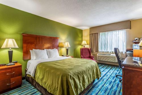 a hotel room with a bed and a desk at Quality Inn in Los Lunas