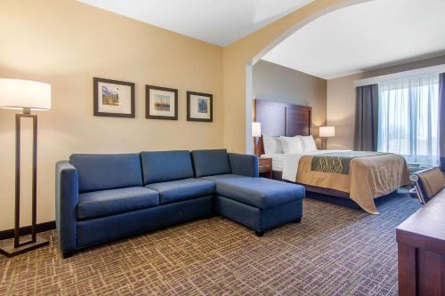 a hotel room with a couch and a bed at Comfort Inn & Suites Norman near University in Norman