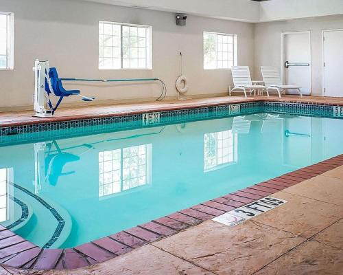 a large swimming pool with blue water in a room at Quality Inn & Suites Roswell North in Roswell