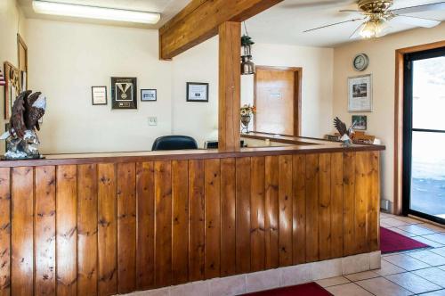 a bar in a room with a wooden fence at Econo Lodge Eagle Nest in Eagle Nest