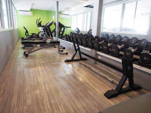 a gym with a bunch of equipment in a room at Baan mek mok in Bangkok