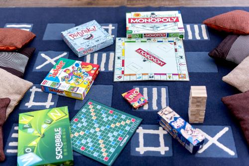 a group of games and cards on a table at SaffronStays Falcon Hill, Lonavala - luxury villa with infinity pool near Lion's Point in Lonavala
