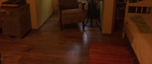 a hallway with a hard wood floor and a chair at Kuldkaru Manor in Valaste