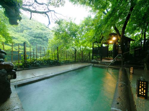 a swimming pool in a yard with a tree at Midoriso in Hioki