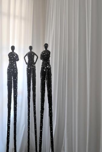 two metal mannequins standing in front of a white curtain at La Maison d'Aix 1785 - Hôtel Particulier & Spa in Aix-en-Provence