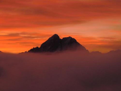 a mountain in the clouds at sunset at Herol - my mountain retreat in Luson