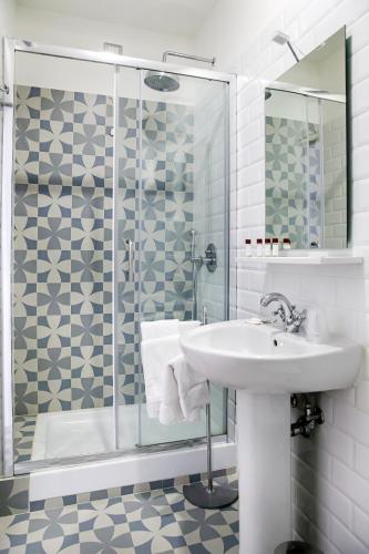a bathroom with a sink and a shower at 1970 Rooms in Naples