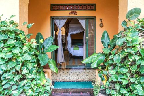 a door leading to a room with a bed at Jogja Village in Yogyakarta