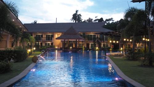 a large swimming pool in front of a building at Chivatara Resort Bang Tao Beach Phuket - SHA in Bang Tao Beach