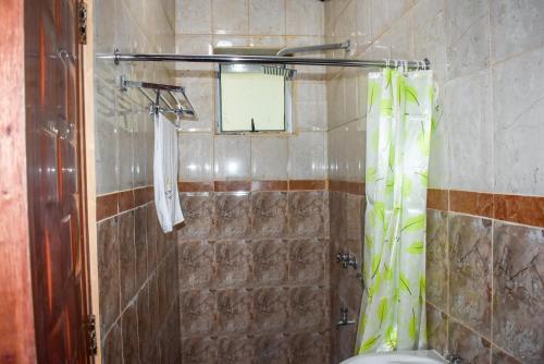 a bathroom with a shower with a shower curtain at Sheratton Regency Hotel in Mombasa