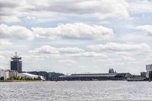 a large body of water with a city in the background at AmicitiA in Amsterdam