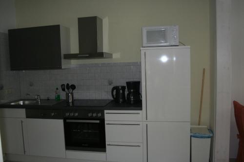 a kitchen with a microwave on top of a refrigerator at Kleine Kirchgasse 28 in Annaberg-Buchholz