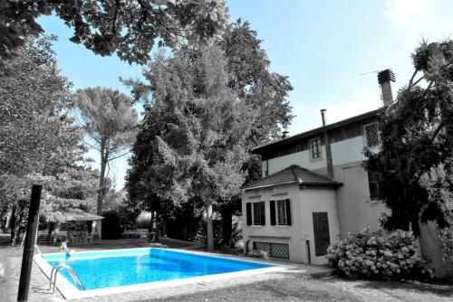 a swimming pool in front of a house at Villa Cesarina, Vallio Terme , Salo’ in Vallio Terme