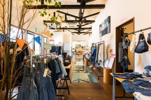 a store with a lot of clothes on racks at Racine Home Harie in Takashima