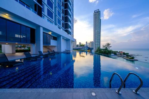 a swimming pool in a building with a view of the ocean at Tanjung Point Residences in George Town
