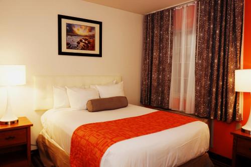 a hotel room with a bed and a window at Howard Johnson by Wyndham Salinas in Salinas