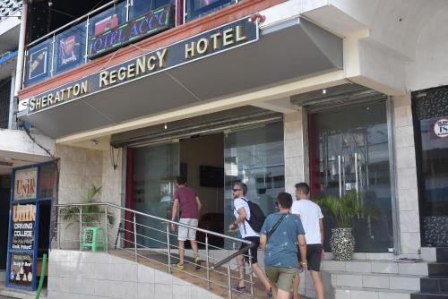 a group of people standing outside of a hotel at Sheratton Regency Hotel in Mombasa