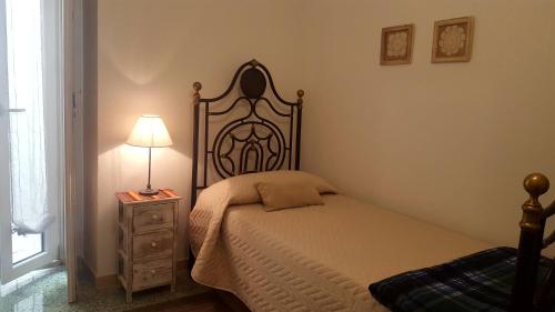 a bedroom with a bed and a lamp on a night stand at Maison de Famille in Acerenza