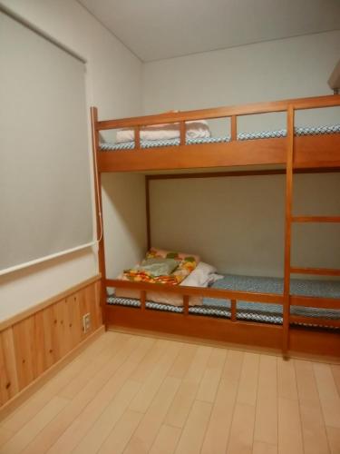 a room with two bunk beds and a chalkboard at Asumi Onsen in Fujiyoshida