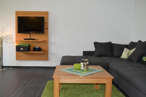 a living room with a couch and a coffee table at Haus Calmsailing in Börgerende-Rethwisch