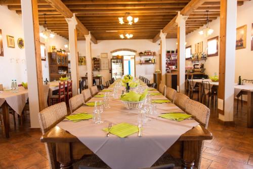 a long table in a restaurant with green napkins and glasses at Agriturismo Corte Del Brenta in Oriago Di Mira