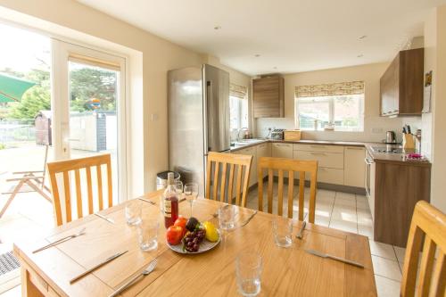 a kitchen with a wooden table with a bowl of fruit on it at 18 Pilgrim’s Way in Thorpeness
