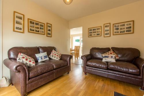 two brown leather couches in a living room at 18 Pilgrim’s Way in Thorpeness
