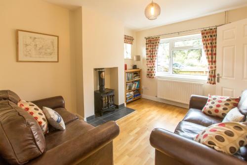 a living room with a couch and a fireplace at 18 Pilgrim’s Way in Thorpeness
