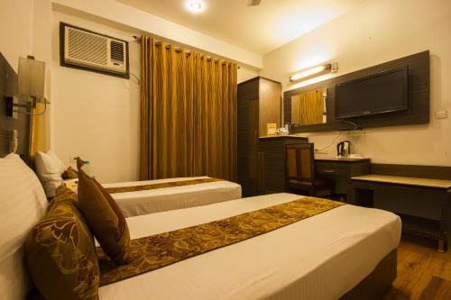 Кровать или кровати в номере Hotel Sunstar Heights