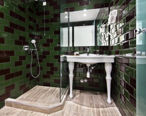 a bathroom with a sink and a shower at Maison 66, Riviera Hotels in Athens
