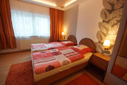 a bedroom with a bed with a quilt on it at Apartment Johanna Oberhof in Oberhof